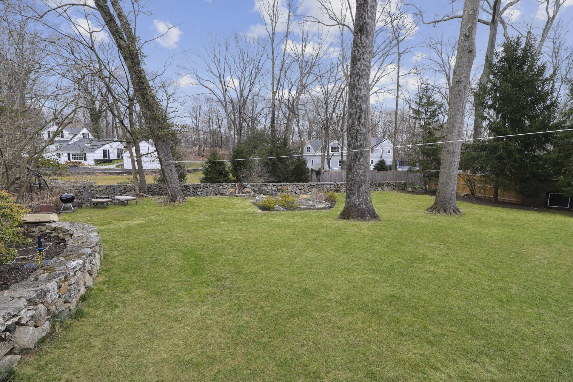 22 Birch Road Darien, CT 06820 - Photo 36 of 40 a backyard of apartments with large trees