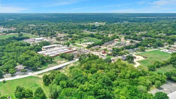 a view of a city with lush green forest