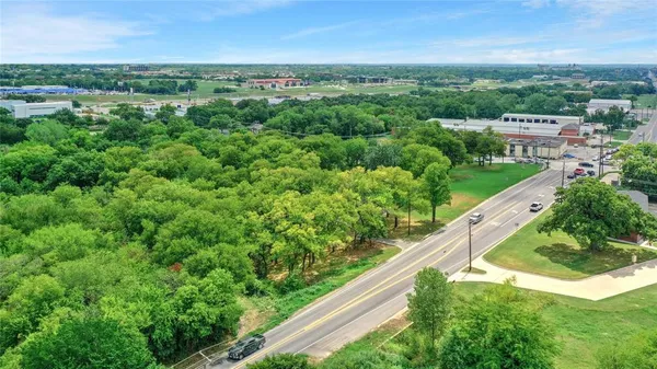 a view of a city with lush green forest