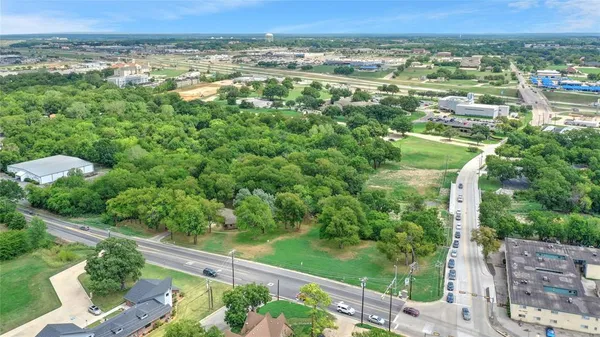 an aerial view of residential house with outdoor space and trees all around