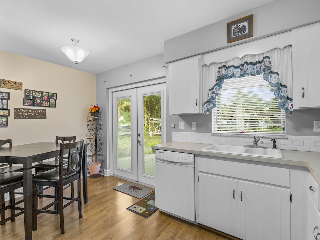 7304 Arthurs Road Fort Pierce, FL 34951 - Photo 14 of 29 a kitchen with a sink cabinets and dining table