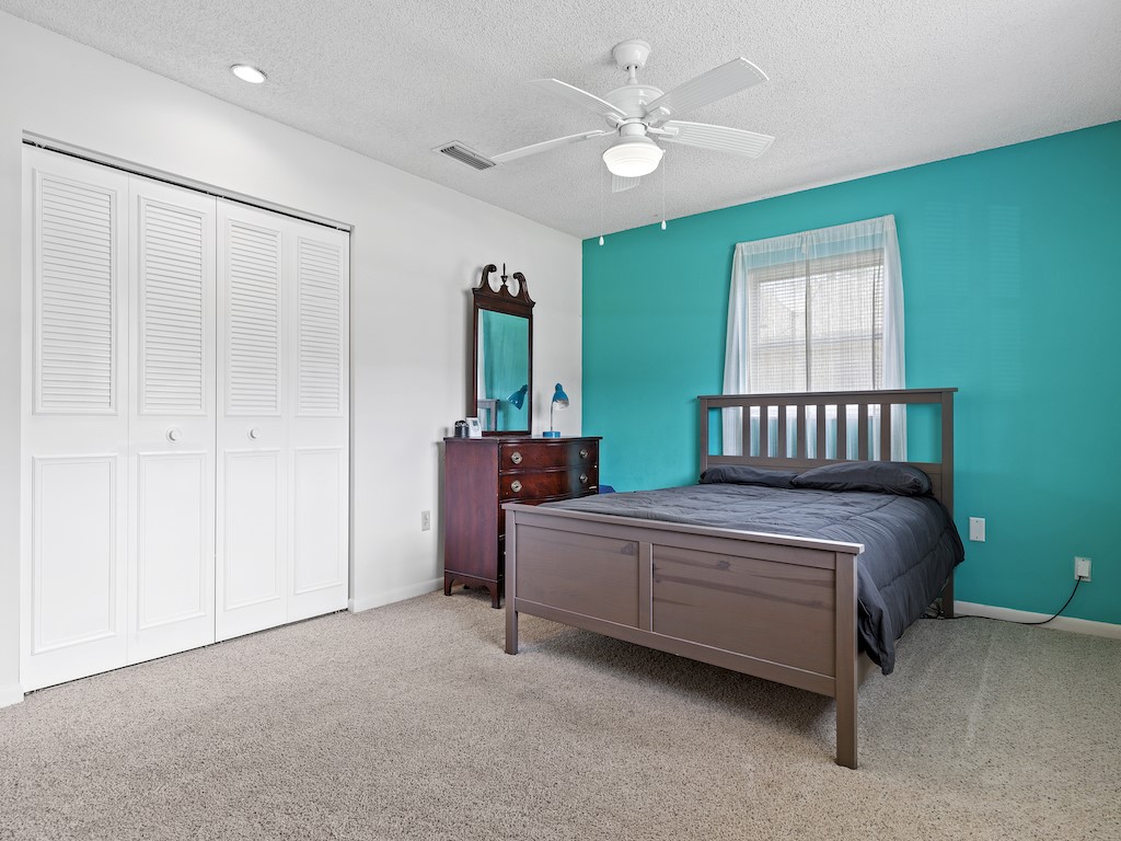 7304 Arthurs Road Fort Pierce, FL 34951 - Photo 17 of 29 a spacious bedroom with a bed and a chandelier