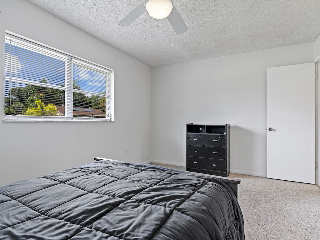 7304 Arthurs Road Fort Pierce, FL 34951 - Photo 19 of 29 a bedroom with a bed and a chandelier