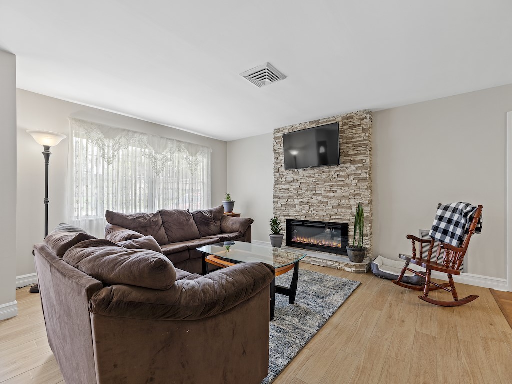 7304 Arthurs Road Fort Pierce, FL 34951 - Photo 2 of 29 a living room with furniture and a fireplace