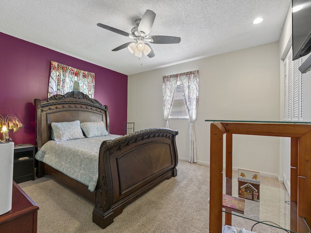 7304 Arthurs Road Fort Pierce, FL 34951 - Photo 21 of 29 a bedroom with a bed and a chandelier