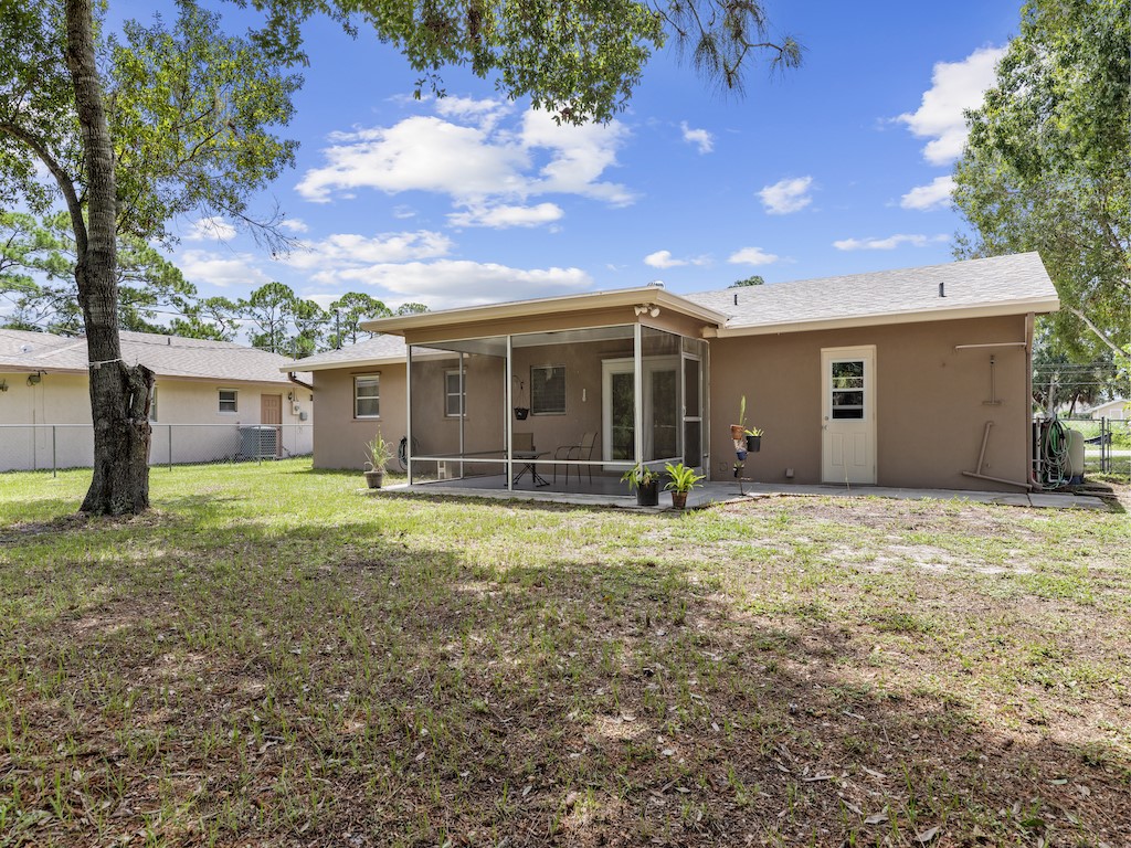7304 Arthurs Road Fort Pierce, FL 34951 - Photo 25 of 29 a view of a house with backyard and garden