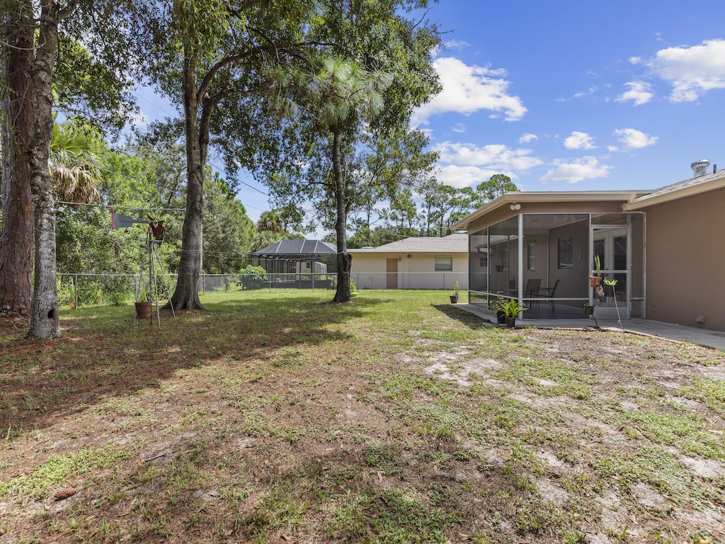 7304 Arthurs Road Fort Pierce, FL 34951 - Photo 26 of 29 a view of a house with yard and a tree