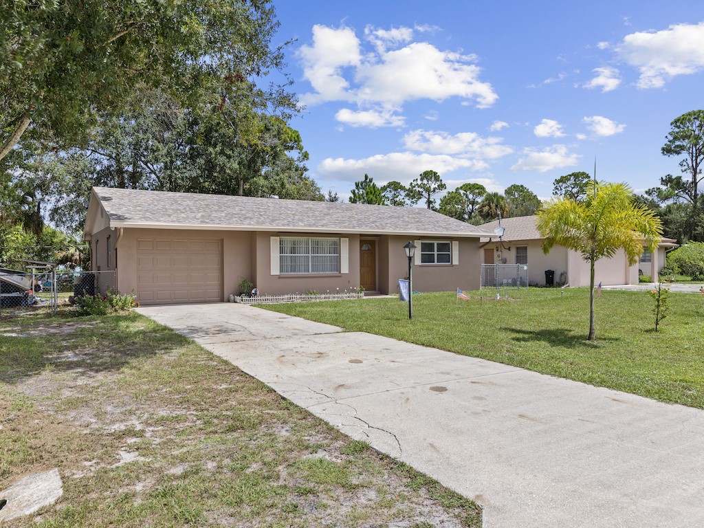 7304 Arthurs Road Fort Pierce, FL 34951 - Photo 27 of 29 a front view of house with yard and green space