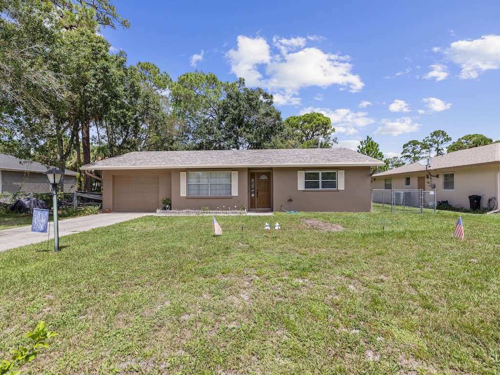 7304 Arthurs Road Fort Pierce, FL 34951 - Photo 29 of 29 a backyard of a house with lots of green space