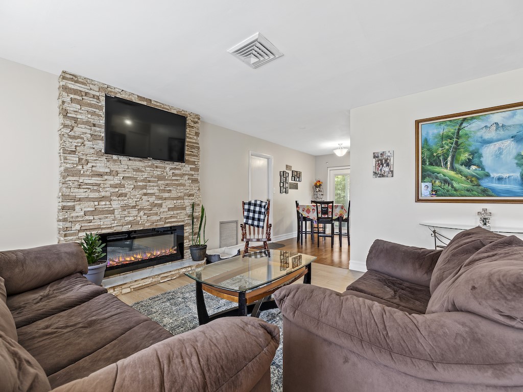 7304 Arthurs Road Fort Pierce, FL 34951 - Photo 4 of 29 a living room with furniture a flat screen tv and a fireplace