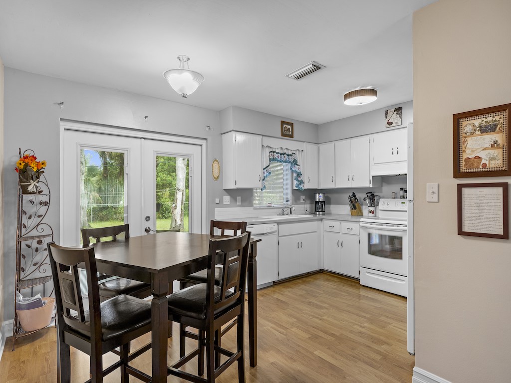 7304 Arthurs Road Fort Pierce, FL 34951 - Photo 10 of 29 a kitchen with a table chairs sink and cabinets