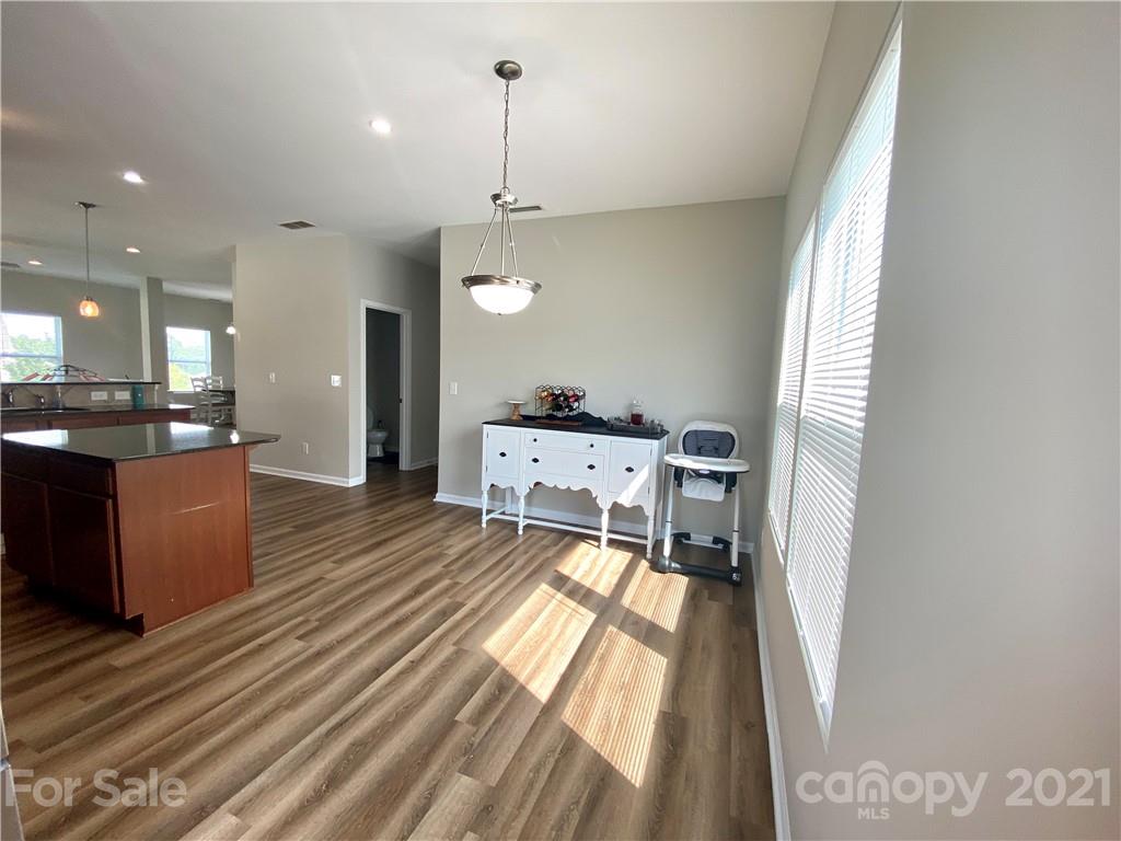 8009 Bryson Road Indian Land, SC 29707 - Photo 13 of 45 a spacious bedroom with a bed and a chandelier