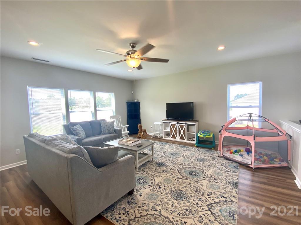 8009 Bryson Road Indian Land, SC 29707 - Photo 21 of 45 a living room with furniture and a flat screen tv