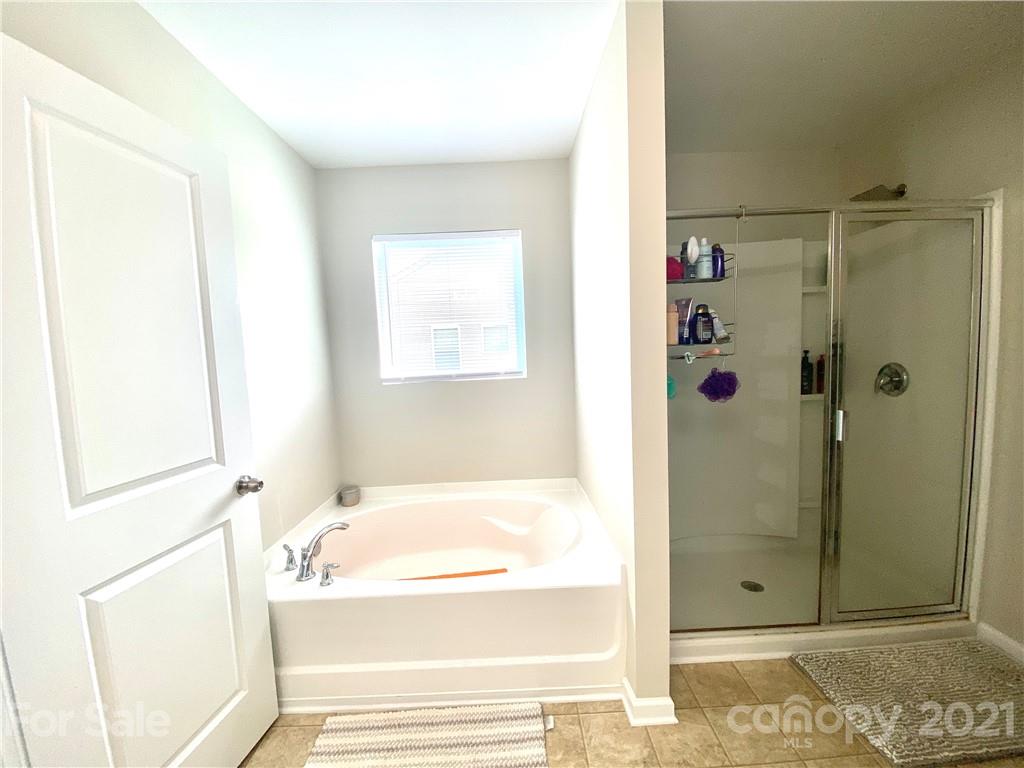 8009 Bryson Road Indian Land, SC 29707 - Photo 29 of 45 a bathroom with a bathtub and shower