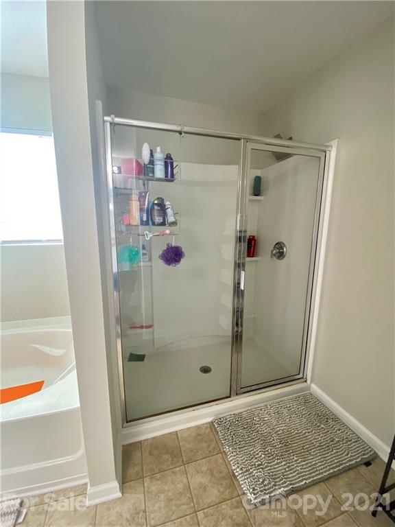 8009 Bryson Road Indian Land, SC 29707 - Photo 30 of 45 a bathroom with a glass shower door