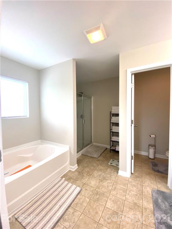 8009 Bryson Road Indian Land, SC 29707 - Photo 32 of 45 a spacious bedroom with a bed and a cabinets