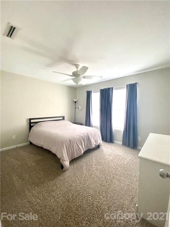 8009 Bryson Road Indian Land, SC 29707 - Photo 35 of 45 a bedroom with a bed and a table