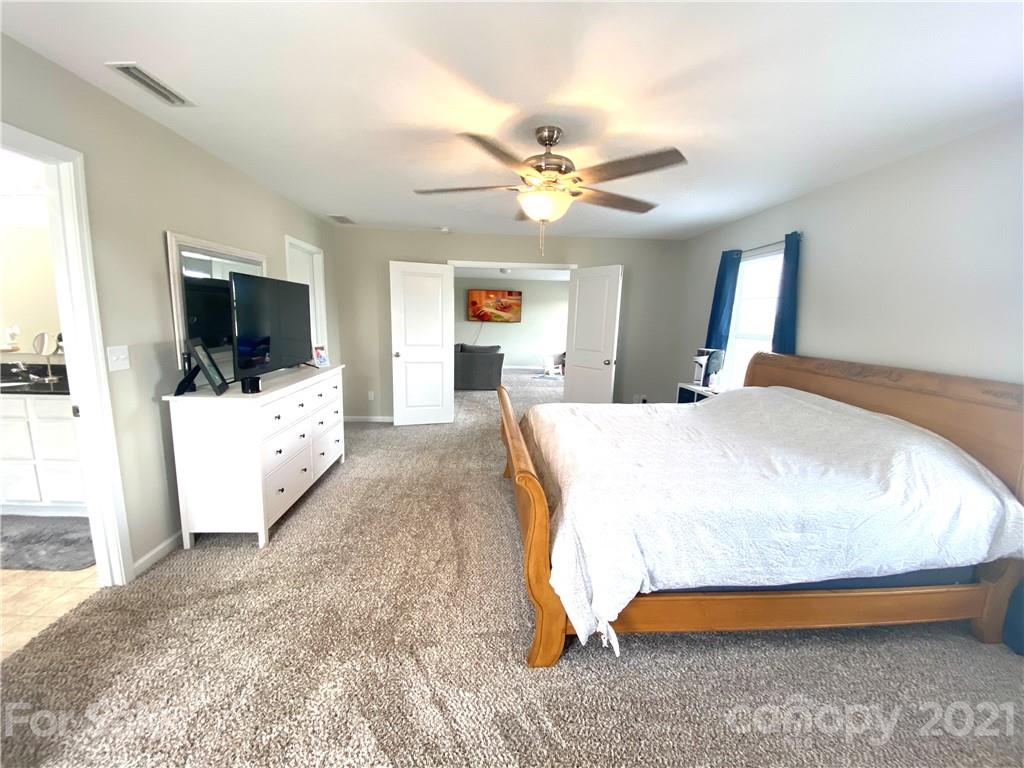 8009 Bryson Road Indian Land, SC 29707 - Photo 36 of 45 a bedroom with a bed and a flat screen tv