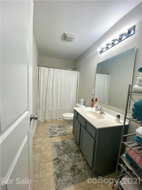 8009 Bryson Road Indian Land, SC 29707 - Photo 42 of 45 a bathroom with a sink mirror and a toilet