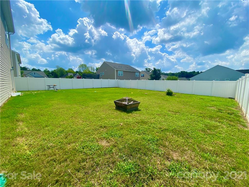 8009 Bryson Road Indian Land, SC 29707 - Photo 44 of 45 a backyard of a house with table and chairs