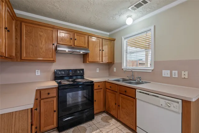 a kitchen with stainless steel appliances granite countertop a sink stove and cabinets
