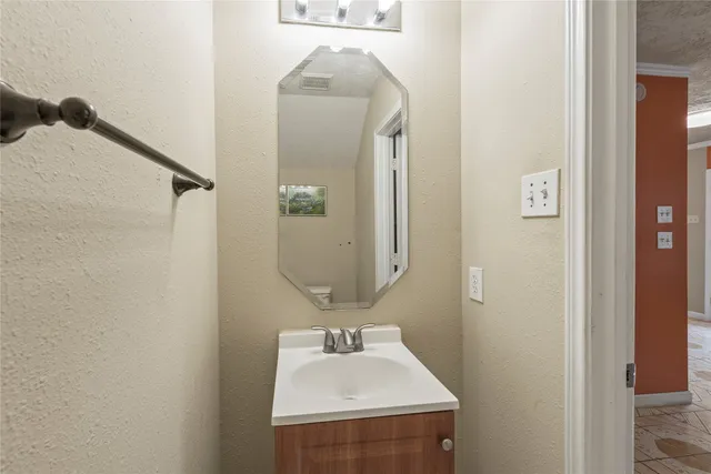 a bathroom with a sink and mirror