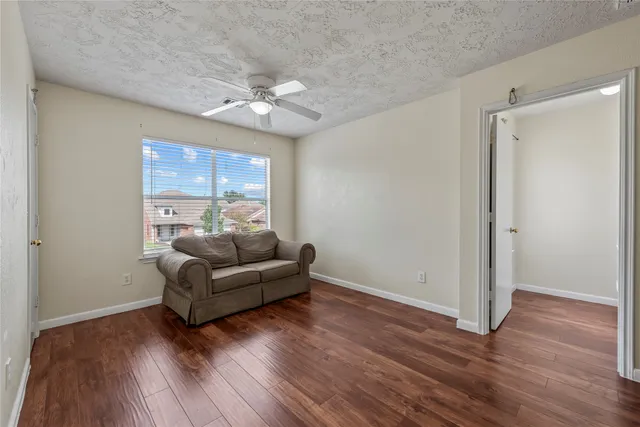 a living room with furniture and wooden floor