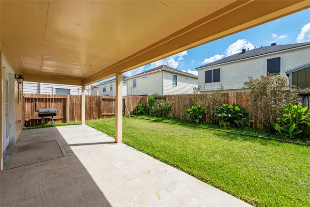 a view of a patio with table and chairs and potted plants