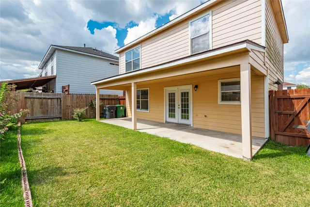 a view of a house with backyard and porch