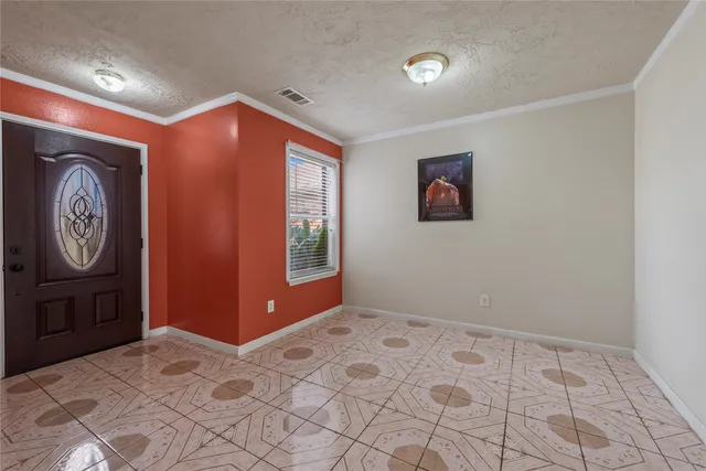 a view of an empty room with window and bathroom