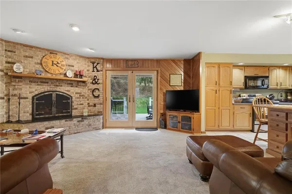 a living room with furniture large window and a flat screen tv