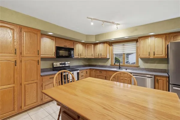 a kitchen with granite countertop a sink and appliances