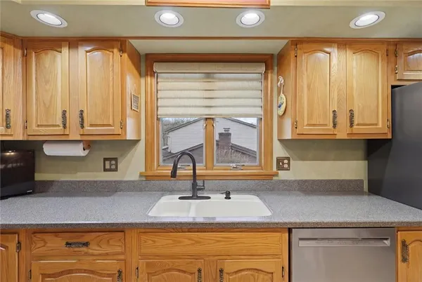 a kitchen with stainless steel appliances granite countertop a sink and a cabinets