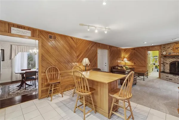a dining room with furniture and a floor to ceiling window