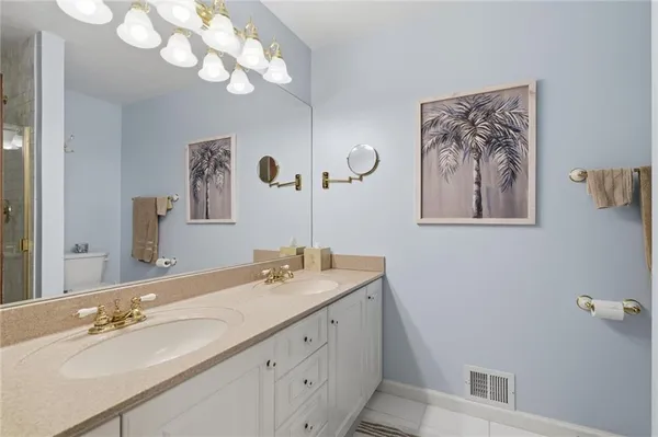a bathroom with a double vanity sink and a mirror