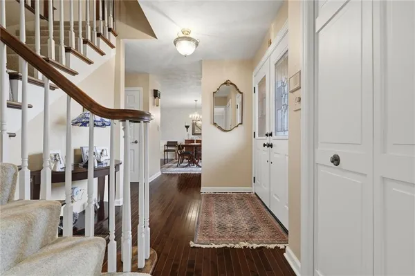 a view of entryway and hall with wooden floor