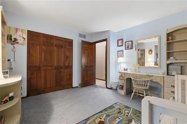 a room with furniture a rug and a window