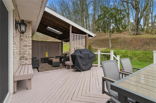 a view of balcony with couch and chairs