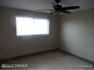 a view of an empty room and a window