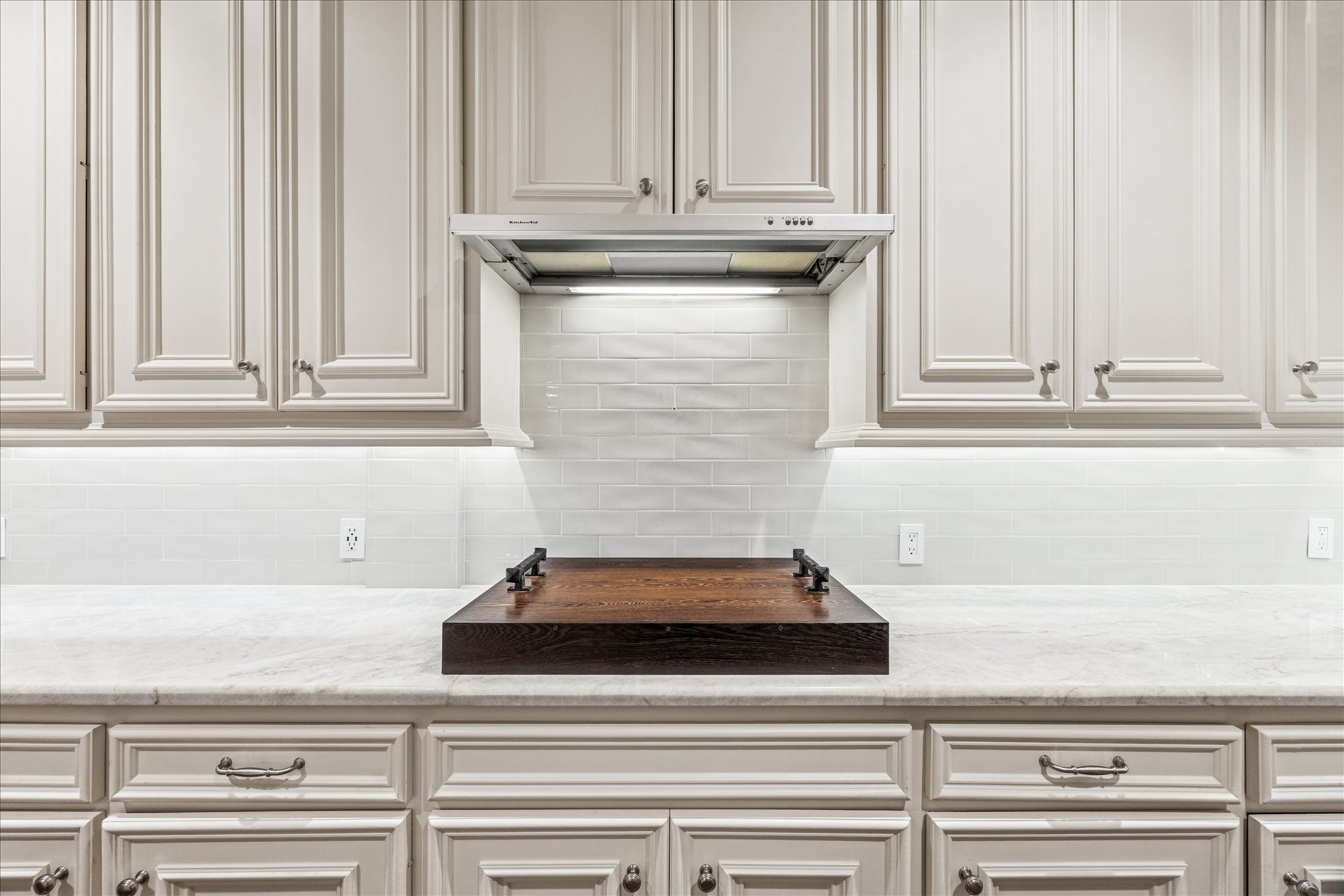 5823 Augusta Court Houston, TX 77057 - Photo 18 of 44 This custom cover for the gas range allows for more counter space and a handsome look.