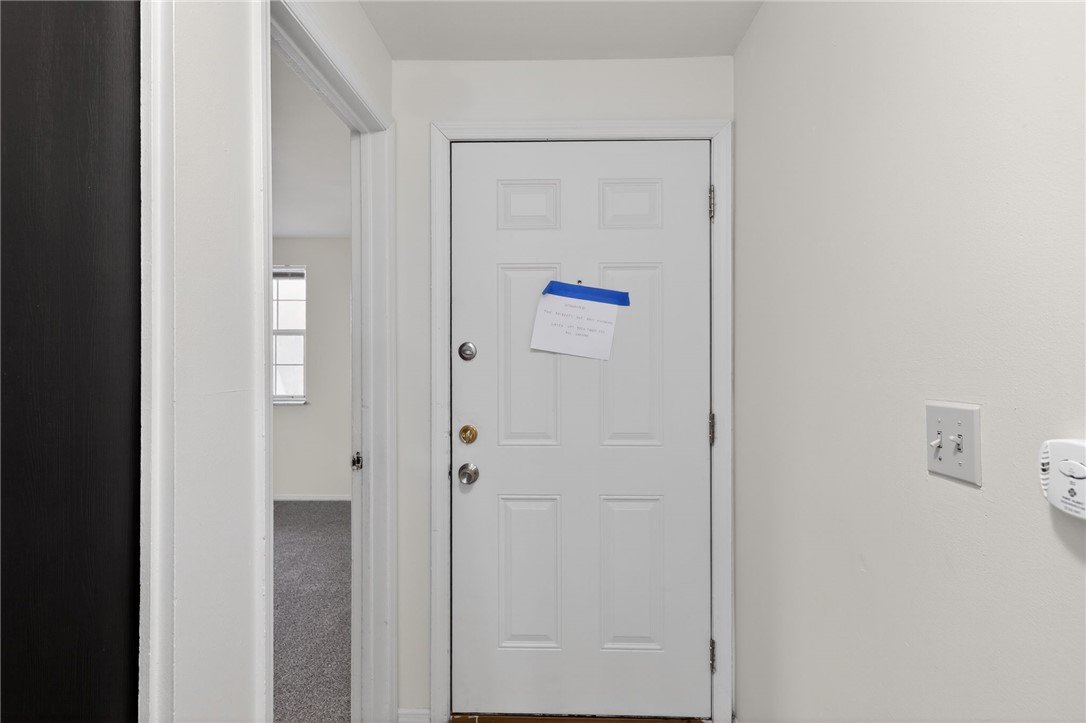 6070 Charlesgate Road Huber Heights, OH 45424 - Photo 7 of 29 The front door opens to an inviting interior with light-colored walls and carpeted floors.