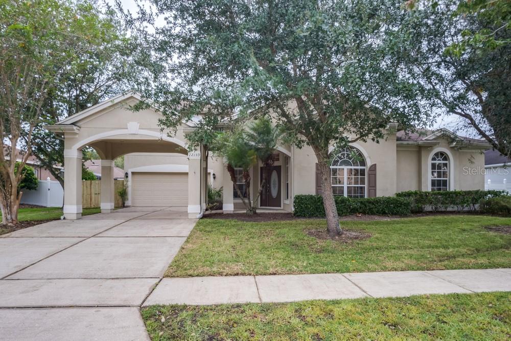 a front view of a house with a yard and garage