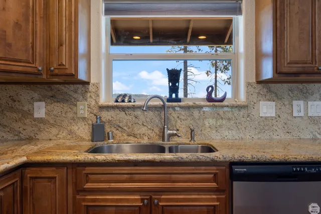 a kitchen with stainless steel appliances granite countertop a sink and cabinets