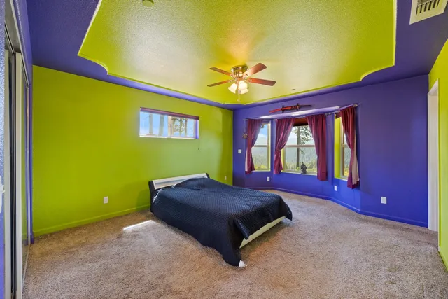 a bed sitting in a room next to a blue wall