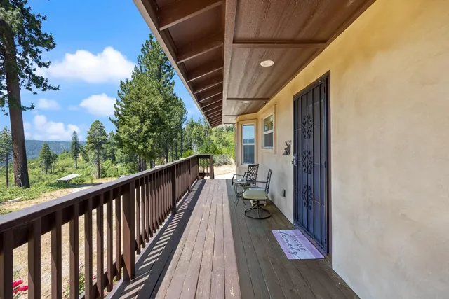 a view of balcony with wooden floor and bench
