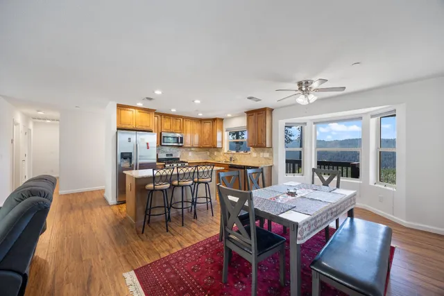 a view of a dining room with furniture and wooden floor