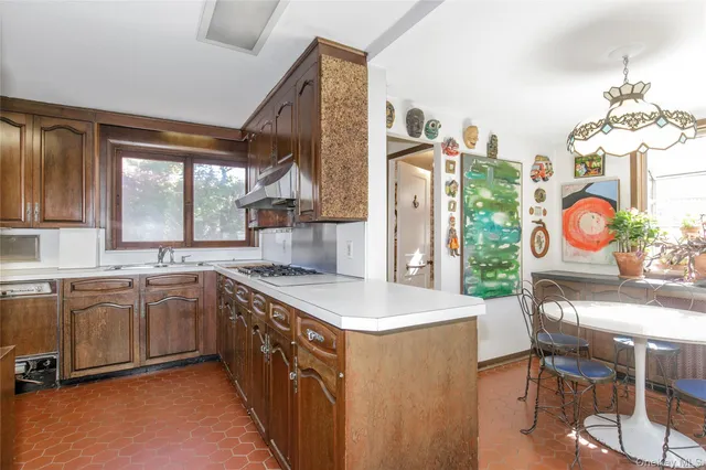 a kitchen with stainless steel appliances granite countertop a sink and a stove