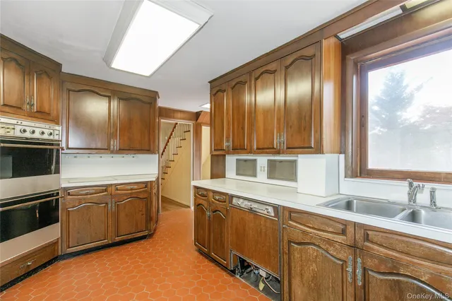 a kitchen with stainless steel appliances granite countertop a sink and a stove