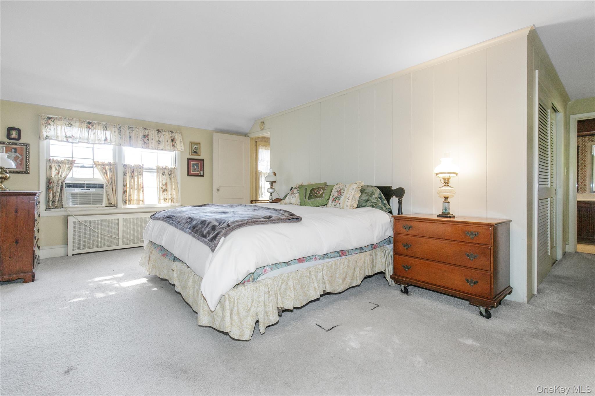 26 Vista Hill Road Great Neck, NY 11021 - Photo 18 of 35 a spacious bedroom with a bed and a window