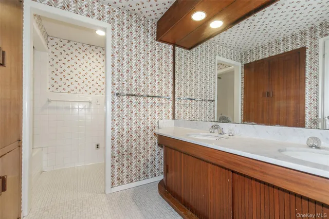 a bathroom with a sink a mirror and shower